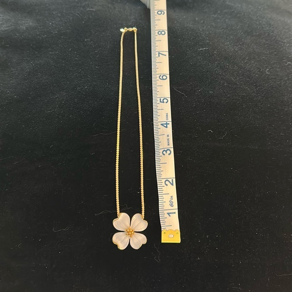 Vintage Monet floral pendant necklace with a delicate gold-tone chain.